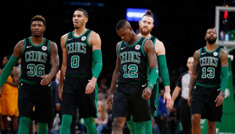 Boston Celtics' Marcus Smart (36), Jayson Tatum (0), Terry Rozier (12) Aron Baynes (46) and Marcus Morris (13) walk to the bench during a timeout in the second half on an NBA basketball game against the Utah Jazz in Boston, Saturday, Nov. 17, 2018. (AP Photo/Michael Dwyer)